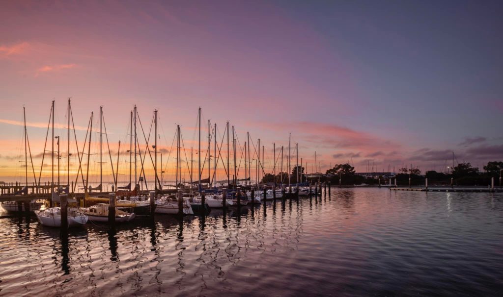 landscape photo of boats on a water at sunrise in mornington, Australia