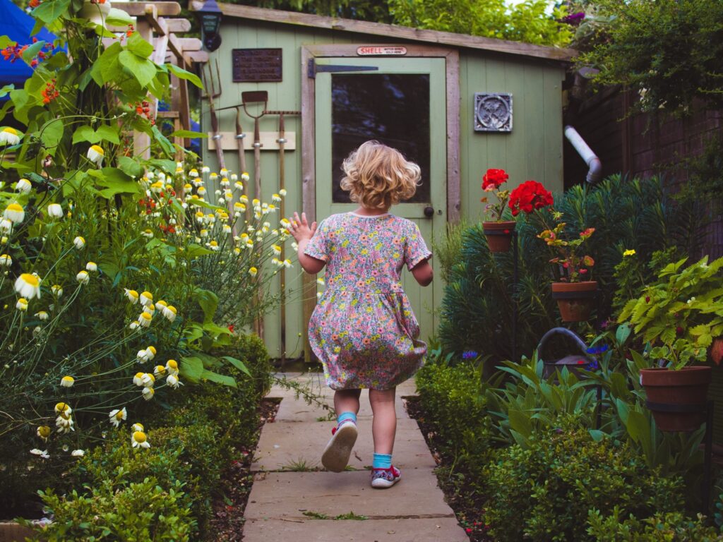 running child in colourful garden