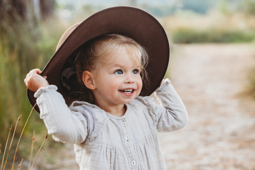 Smiling child in photo with big fun hat