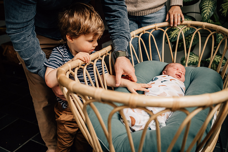 father mother toddler sibling newborn lifestyle portrait