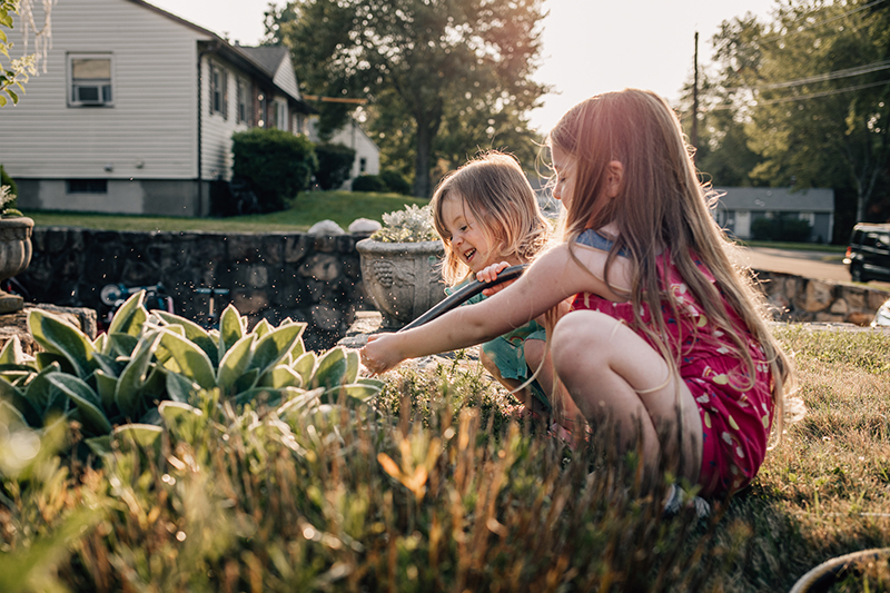 kids portraits lifestyle two girls in garden golden hour