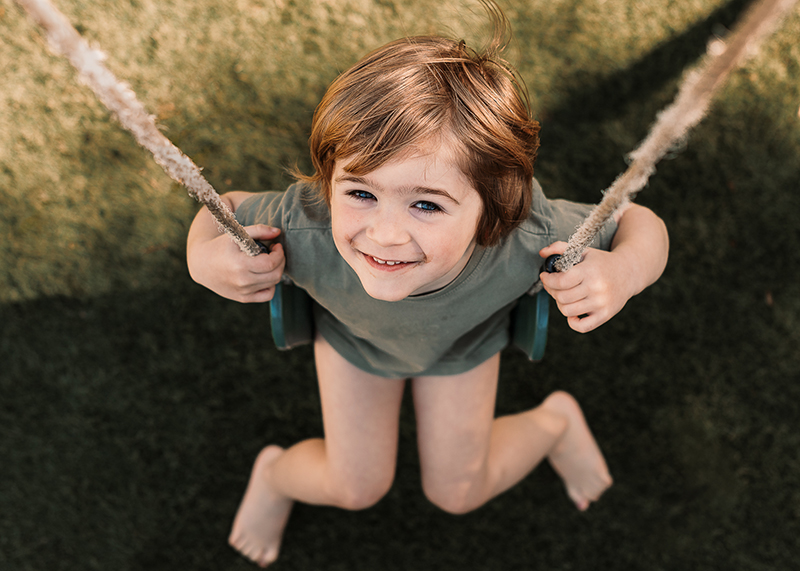 smiling child on swing creative photo