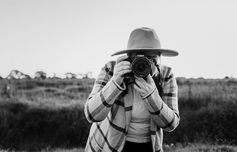 self portrait of woman with camera