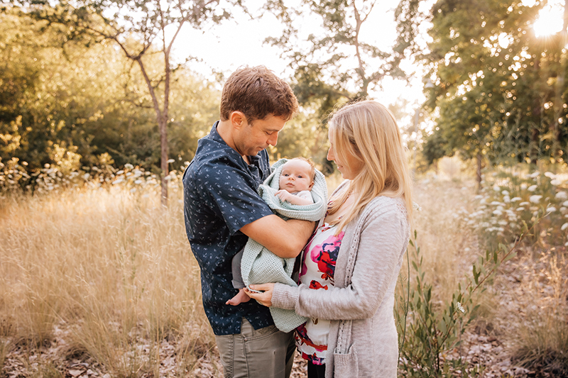 mother father mum dad newborn field portrait