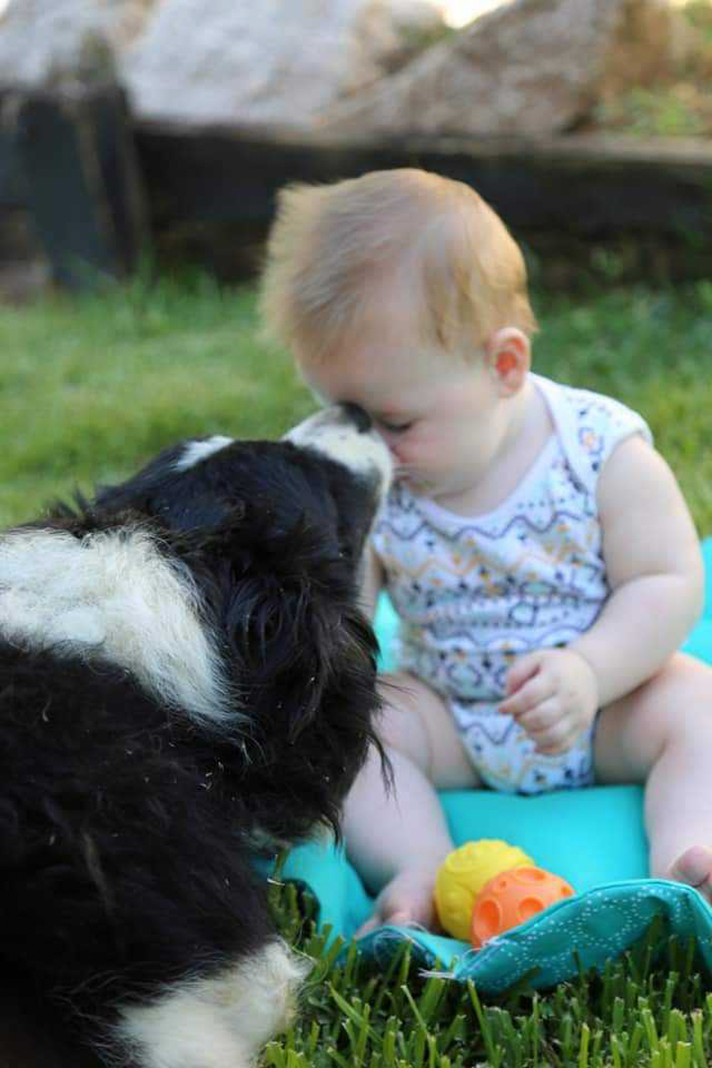 snapshot of young baby with puppy