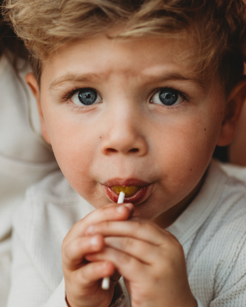 close up photo of toddler with lollipop