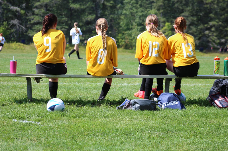 teens soccer uniform game bench yellow jerseys critiquing