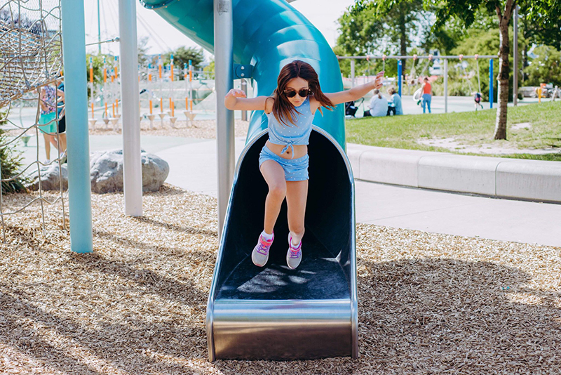 girl in blue on slide playground photo critiquing